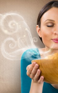 Beautiful woman holding hot fresh smelling oat cookies with clos